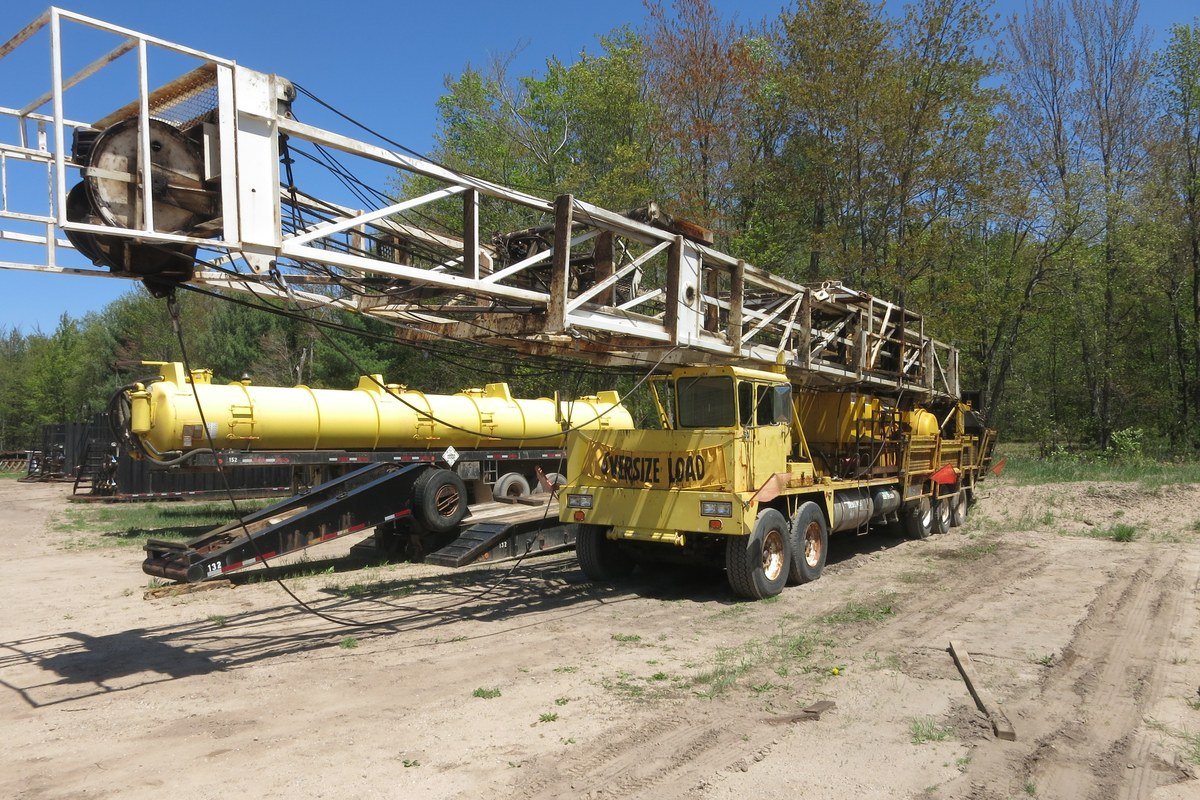 A truck-mounted crane extended on a construction site.