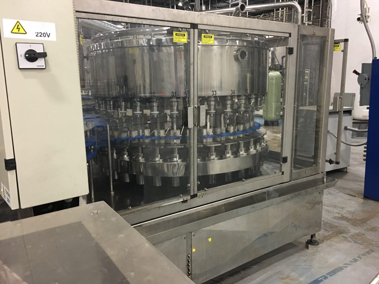 A rotary bottle filler in a beverage plant.