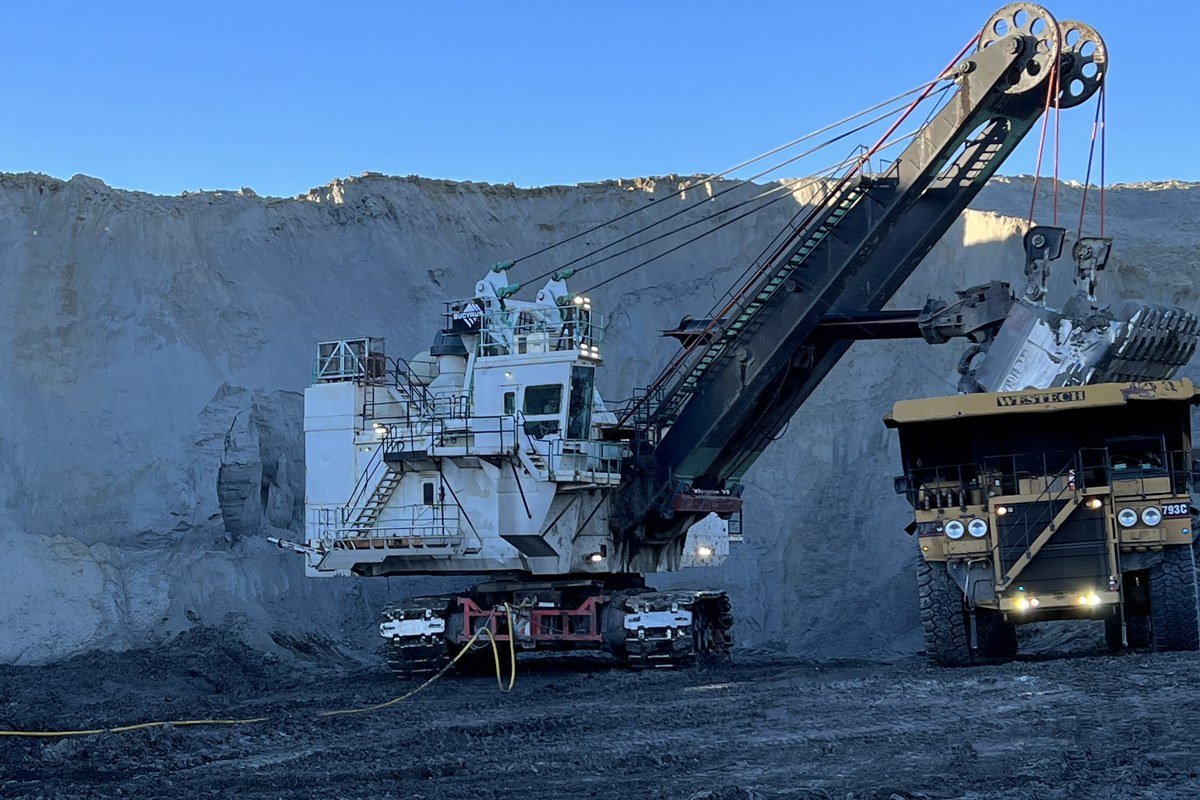 An electric rope shovel loading an off-highway haul truck at a surface coal mine.