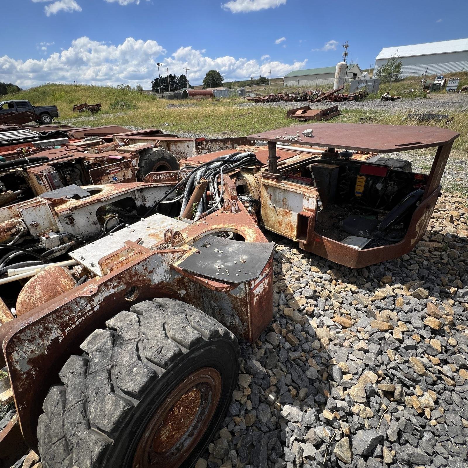The stripped, burned-out remains of mobile equipment sitting in a scrap yard.